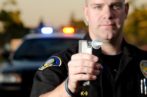 Seattle police officer offering a breath test to a King County resident about to be arrested and charged with drunk driving