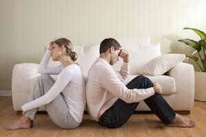 Couple sitting back to back
